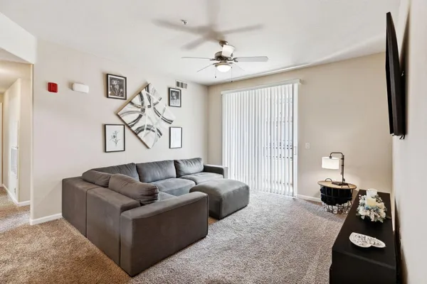 a living room with furniture and a flat screen tv