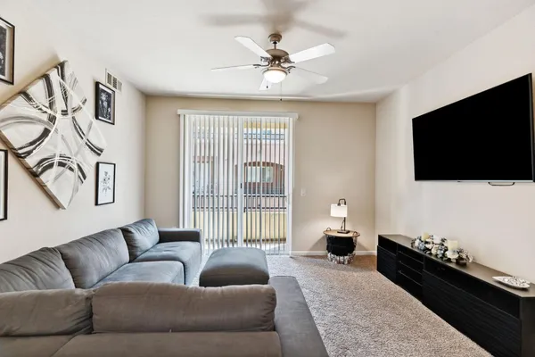a living room with furniture and a flat screen tv