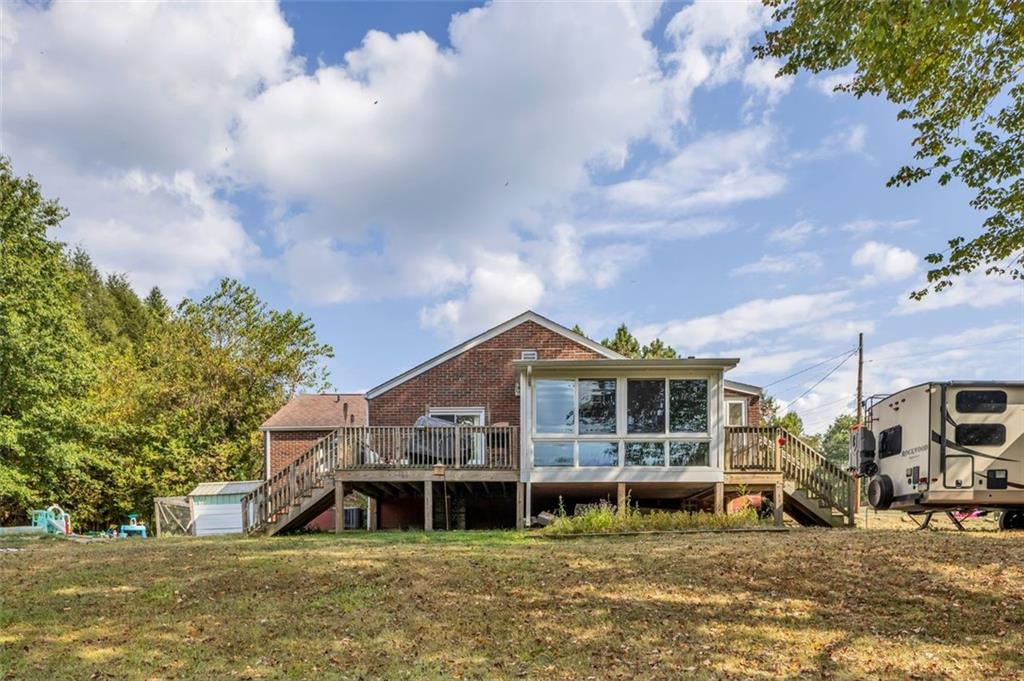 634 Rose Street Apollo, PA 15613 - Photo 2 of 29 a view of a big house with large windows and a big yard with large trees