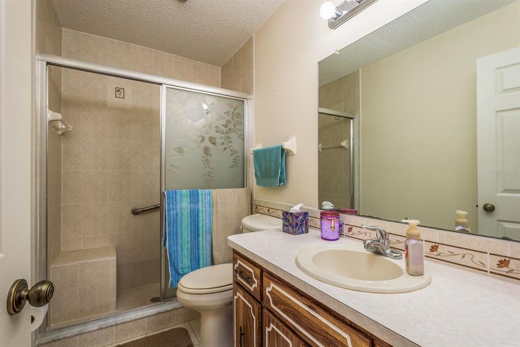 9910 Eagles Point Circle, Unit 3 Port Richey, FL 34668 - Photo 18 of 25 a bathroom with a sink toilet and shower