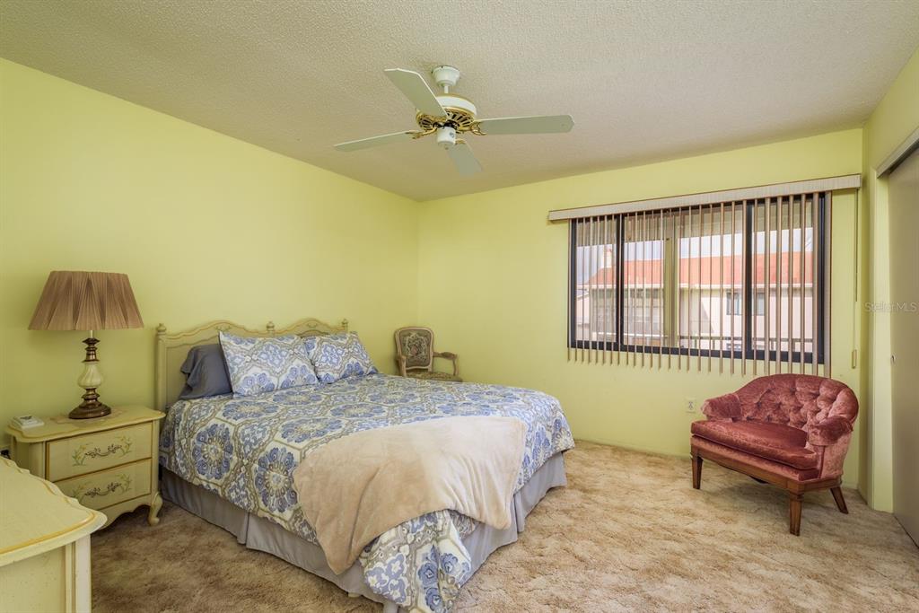 9910 Eagles Point Circle, Unit 3 Port Richey, FL 34668 - Photo 19 of 25 a bedroom with a bed and a window
