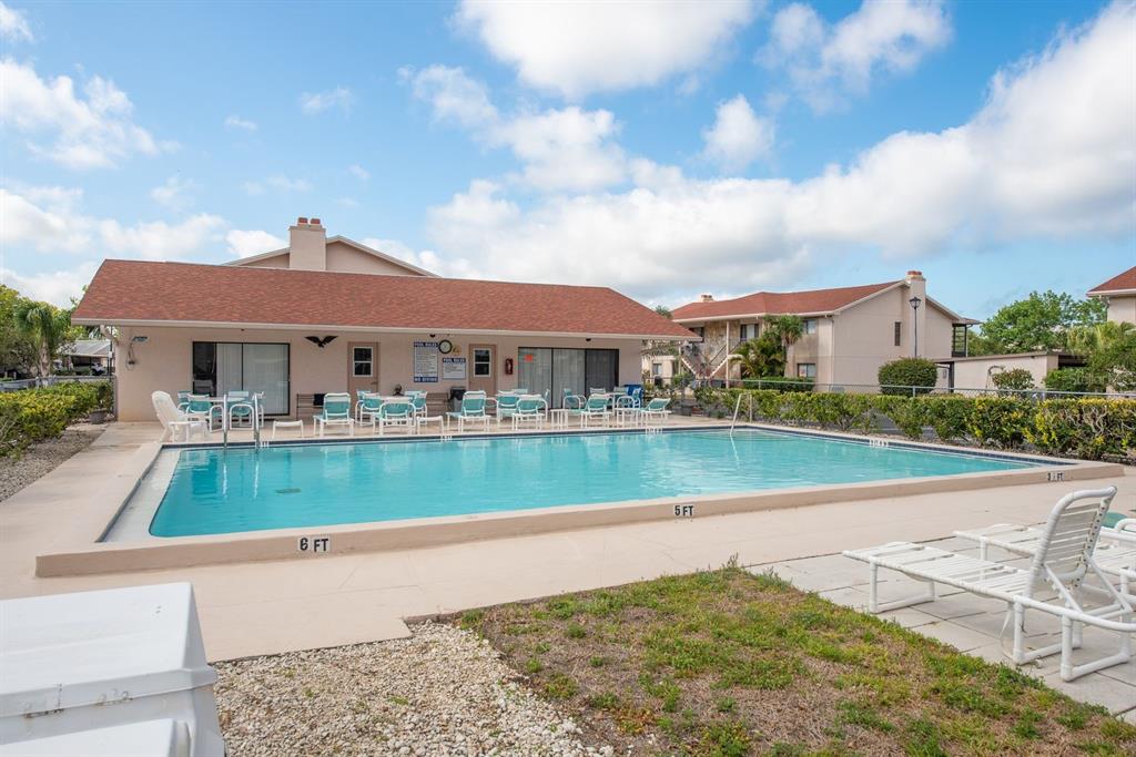 9910 Eagles Point Circle, Unit 3 Port Richey, FL 34668 - Photo 25 of 25 a view of houses with city street and lake view