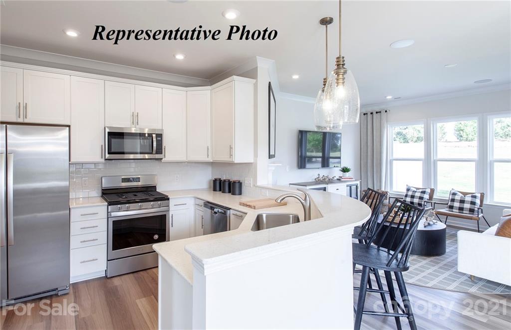 943 Wicawa Road, Unit 300 Fort Mill, SC 29708 - Photo 4 of 24 a kitchen with sink cabinets and stainless steel appliances