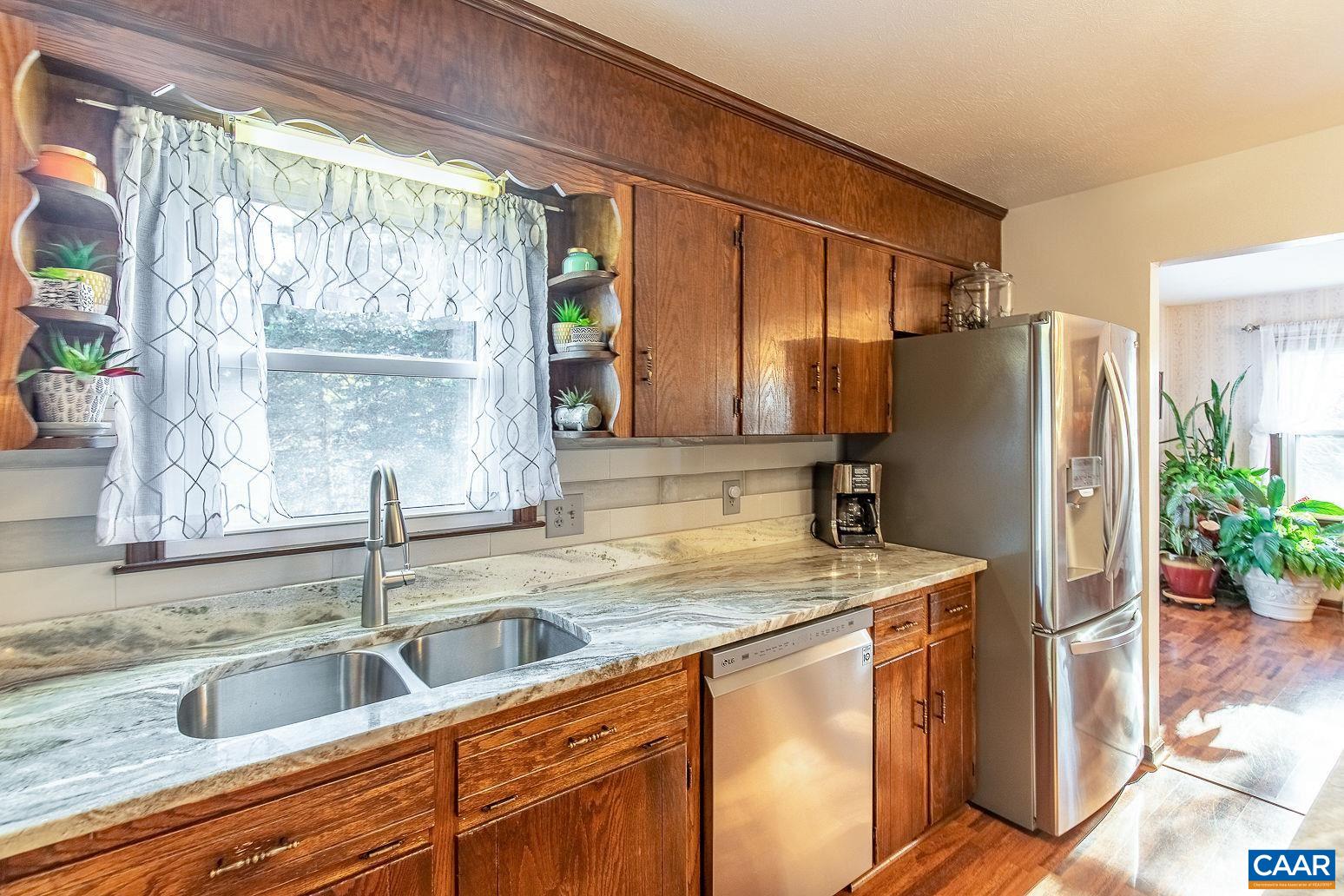 3248 Welsh Run Road Ruckersville, VA 22968 - Photo 12 of 43 a kitchen with stainless steel appliances granite countertop a refrigerator a sink and a stove