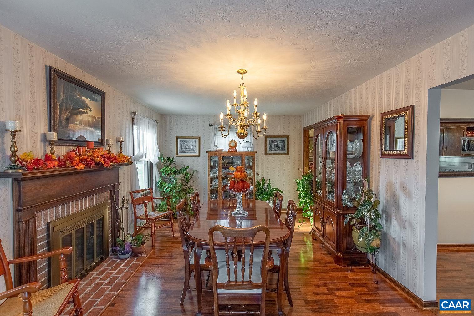 3248 Welsh Run Road Ruckersville, VA 22968 - Photo 16 of 43 a view of a dining room with furniture and chandelier