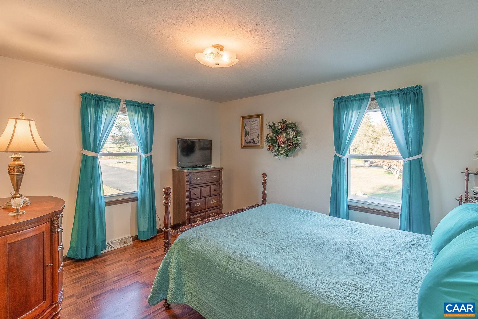 3248 Welsh Run Road Ruckersville, VA 22968 - Photo 19 of 43 a bedroom with a bed and a window