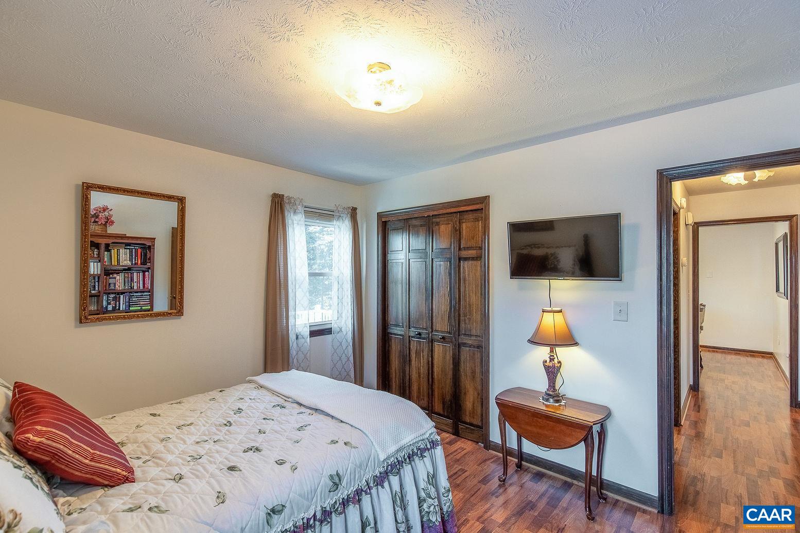 3248 Welsh Run Road Ruckersville, VA 22968 - Photo 21 of 43 a bedroom with a bed and wooden floor