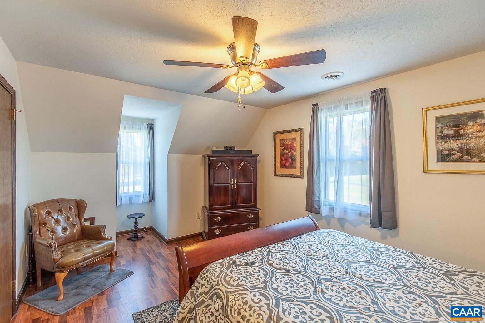 3248 Welsh Run Road Ruckersville, VA 22968 - Photo 24 of 43 a bedroom with a bed and wooden floor