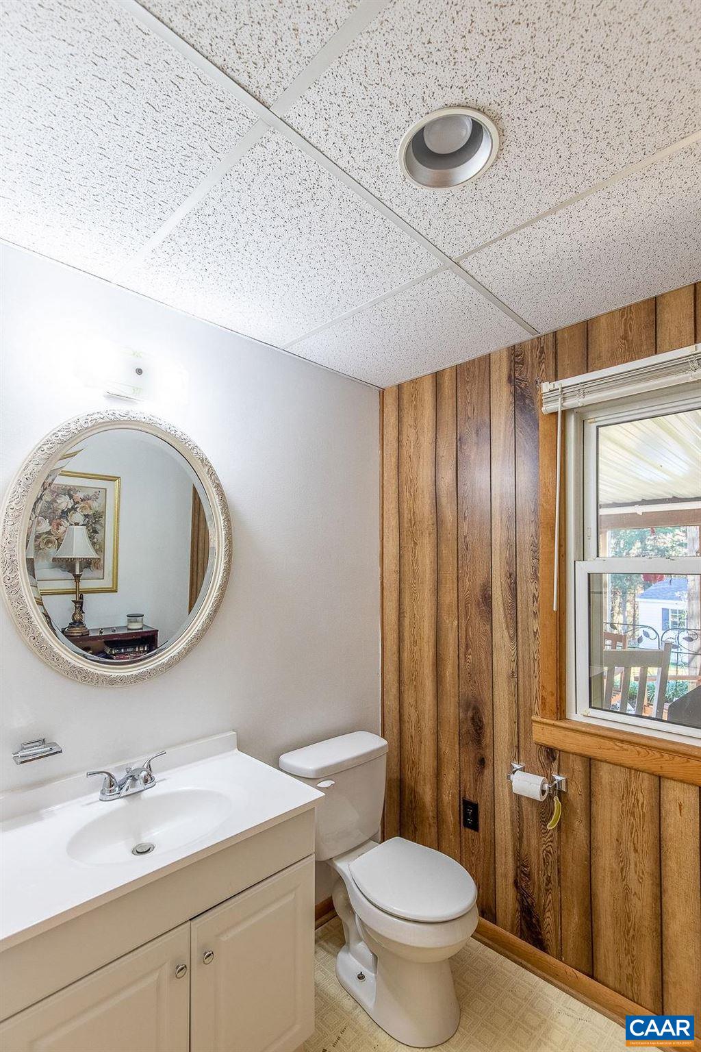 3248 Welsh Run Road Ruckersville, VA 22968 - Photo 28 of 43 a bathroom with a toilet a sink and mirror