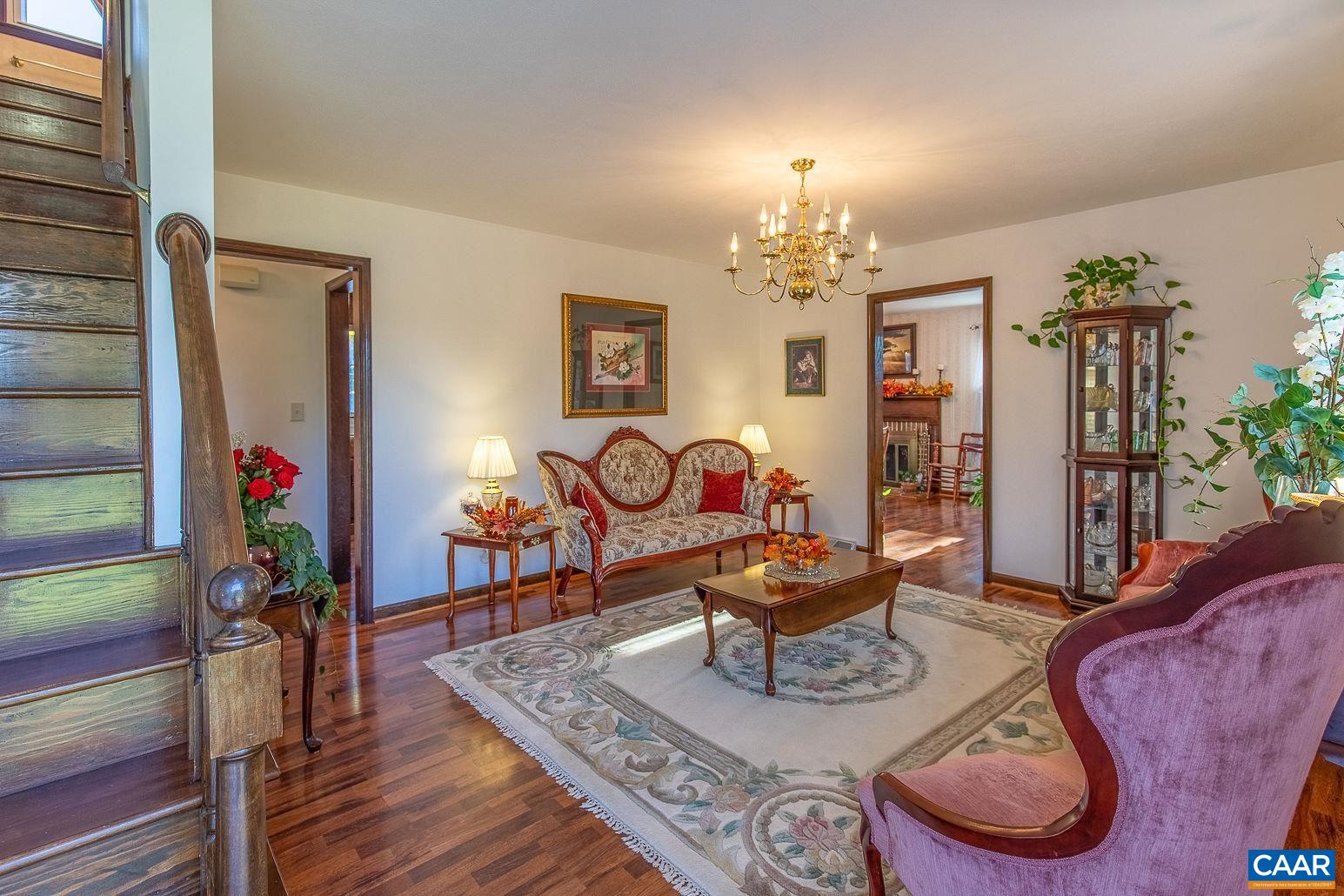 3248 Welsh Run Road Ruckersville, VA 22968 - Photo 6 of 43 a living room with furniture and a chandelier