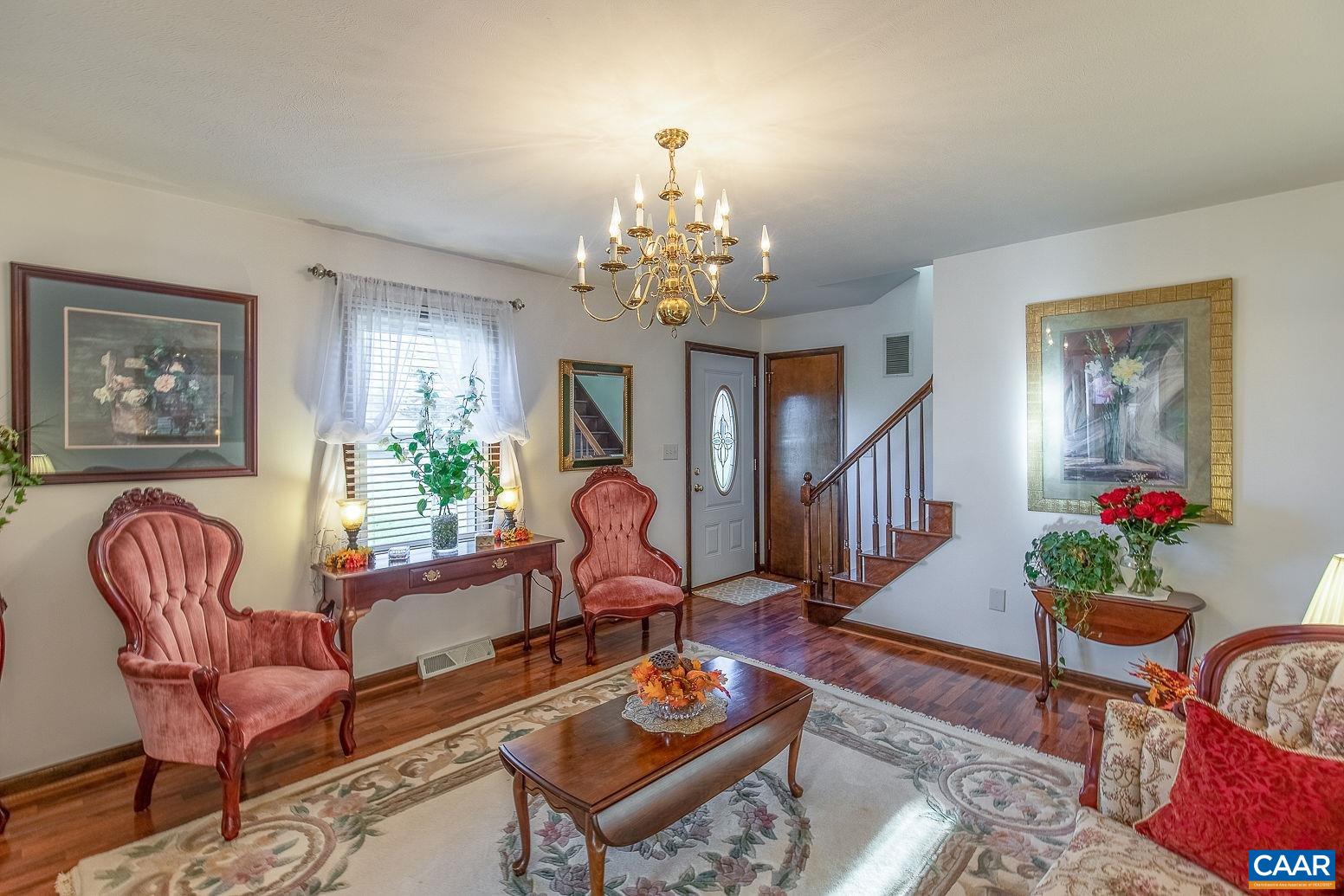 3248 Welsh Run Road Ruckersville, VA 22968 - Photo 7 of 43 a living room with furniture a rug and a chandelier