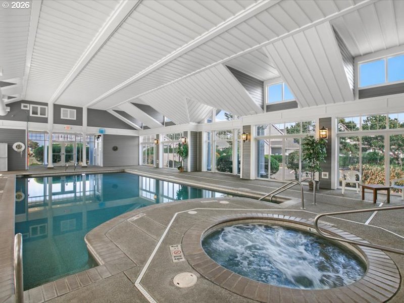 Southwest 61st Street, Unit 7300 South Beach, OR 97366 - Photo 15 of 26 a view of a house with a swimming pool