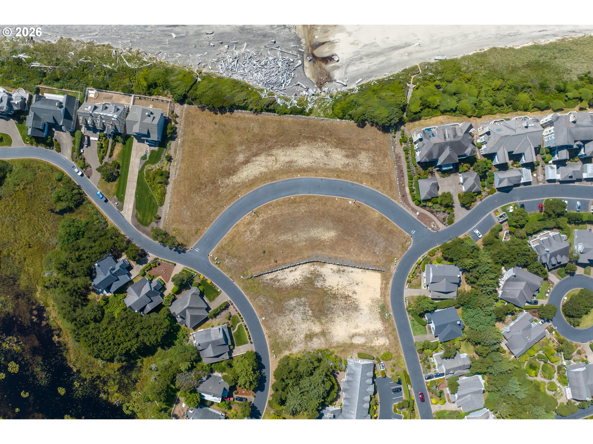 Southwest 61st Street, Unit 7300 South Beach, OR 97366 - Photo 8 of 26 an aerial view of a house with a garden and lake view