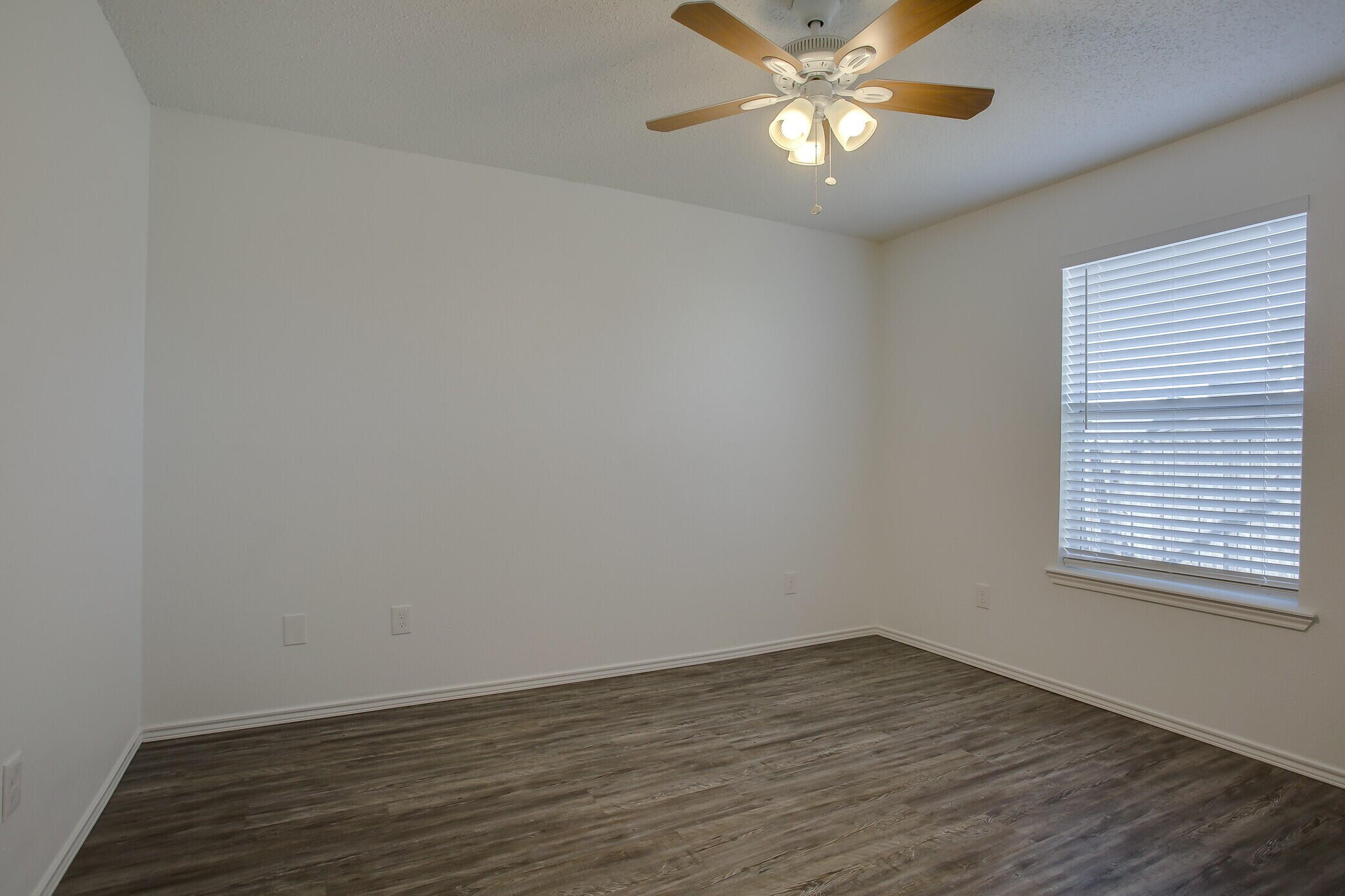 2514 108th Drive Lubbock, TX 79423 - Photo 13 of 16 wooden floor in an empty room with a window
