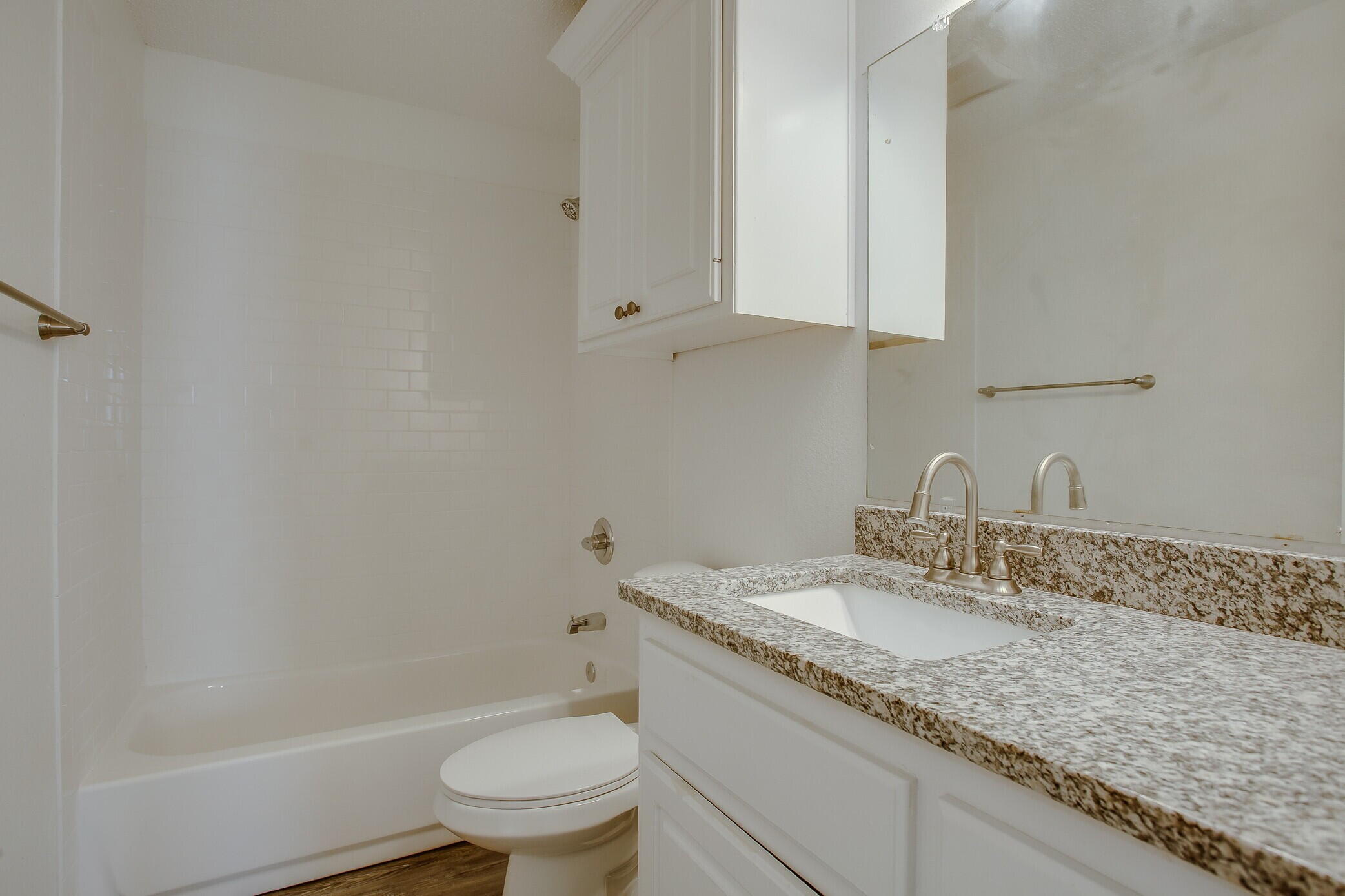 2514 108th Drive Lubbock, TX 79423 - Photo 14 of 16 a bathroom with a granite countertop sink a toilet and bathtub