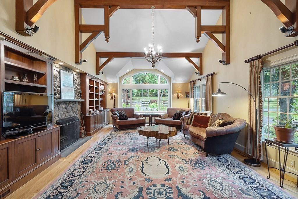 18 Wheeler Road Lincoln, MA 01773 - Photo 11 of 42 a living room with fireplace furniture and a flat screen tv