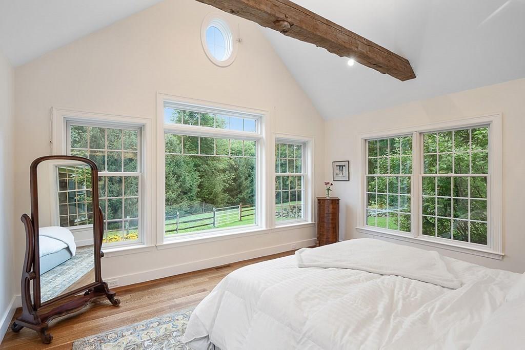 18 Wheeler Road Lincoln, MA 01773 - Photo 16 of 42 a bedroom with a large bed and a large window