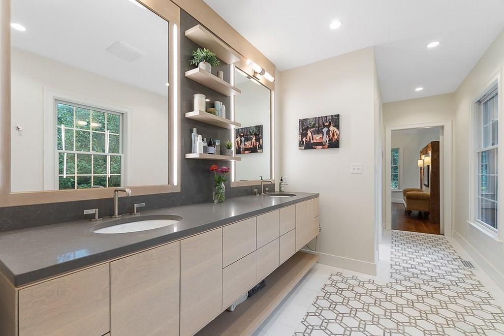 18 Wheeler Road Lincoln, MA 01773 - Photo 17 of 42 a bathroom with a double vanity sink a mirror and a bathtub