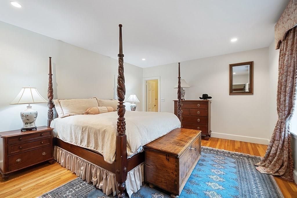 18 Wheeler Road Lincoln, MA 01773 - Photo 19 of 42 a bedroom with a bed and wooden floor