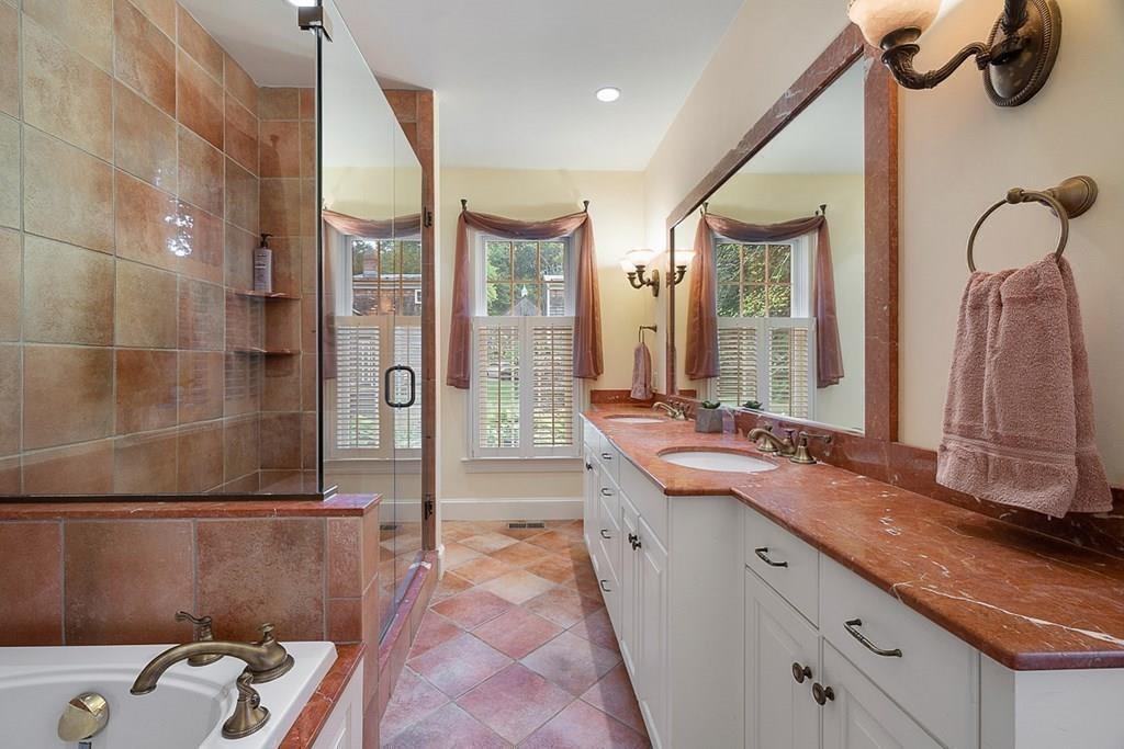 18 Wheeler Road Lincoln, MA 01773 - Photo 20 of 42 a bathroom with a granite countertop sink a mirror and a shower