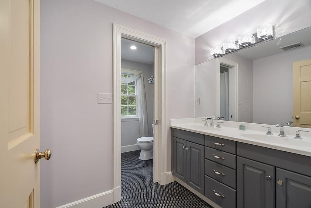 18 Wheeler Road Lincoln, MA 01773 - Photo 25 of 42 a bathroom with a double vanity sink toilet and mirror