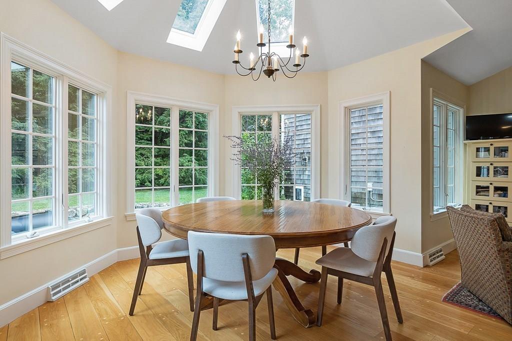 18 Wheeler Road Lincoln, MA 01773 - Photo 9 of 42 a dining room with furniture a chandelier and wooden floor