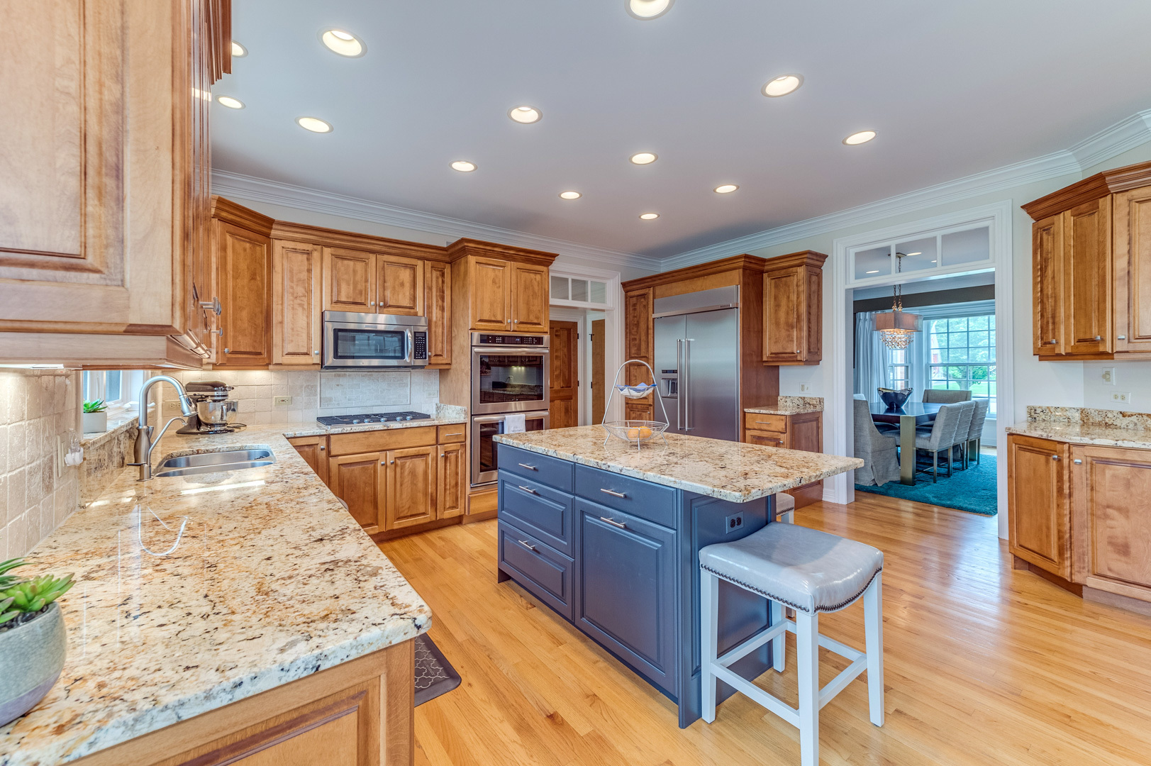 1009 Sutton Place St. Charles, IL 60174 - Photo 11 of 41 a kitchen with large counter top space appliances and a center island