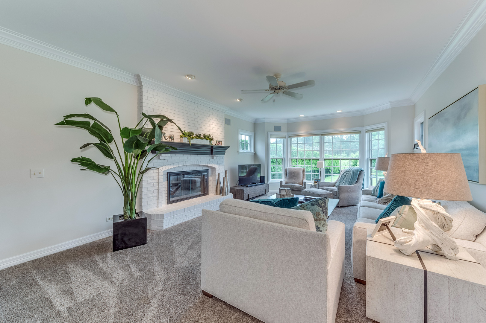 1009 Sutton Place St. Charles, IL 60174 - Photo 13 of 41 a living room with furniture a fireplace and a potted plant