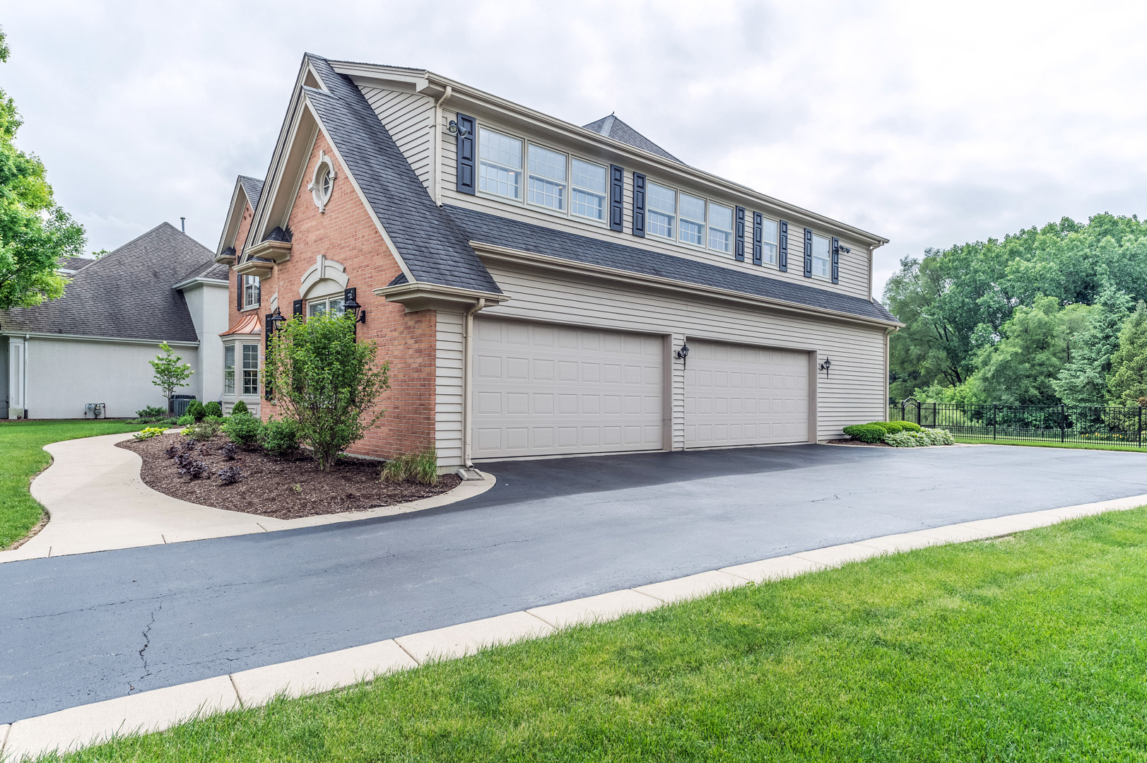 1009 Sutton Place St. Charles, IL 60174 - Photo 38 of 41 a front view of a house with garage and plants
