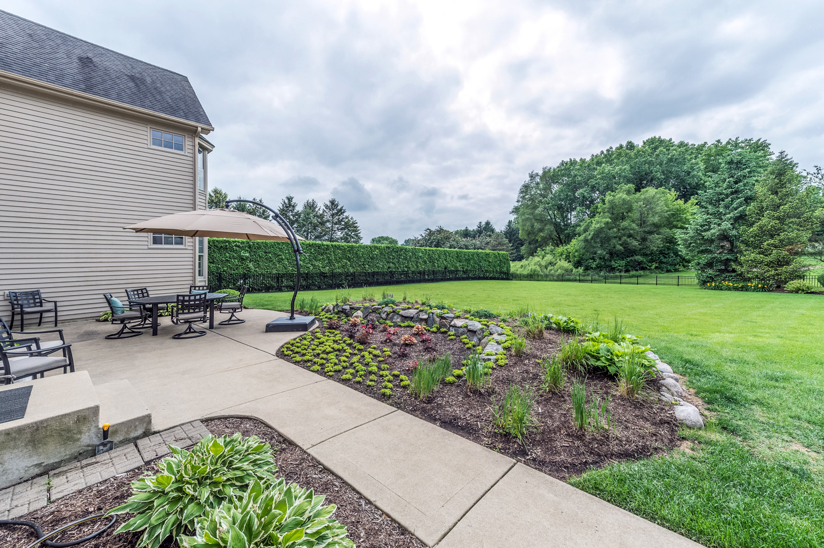 1009 Sutton Place St. Charles, IL 60174 - Photo 39 of 41 a view of a chair and table in patio with a yard