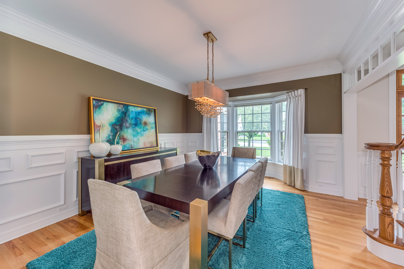 1009 Sutton Place St. Charles, IL 60174 - Photo 6 of 41 a dining room with furniture a chandelier and wooden floor