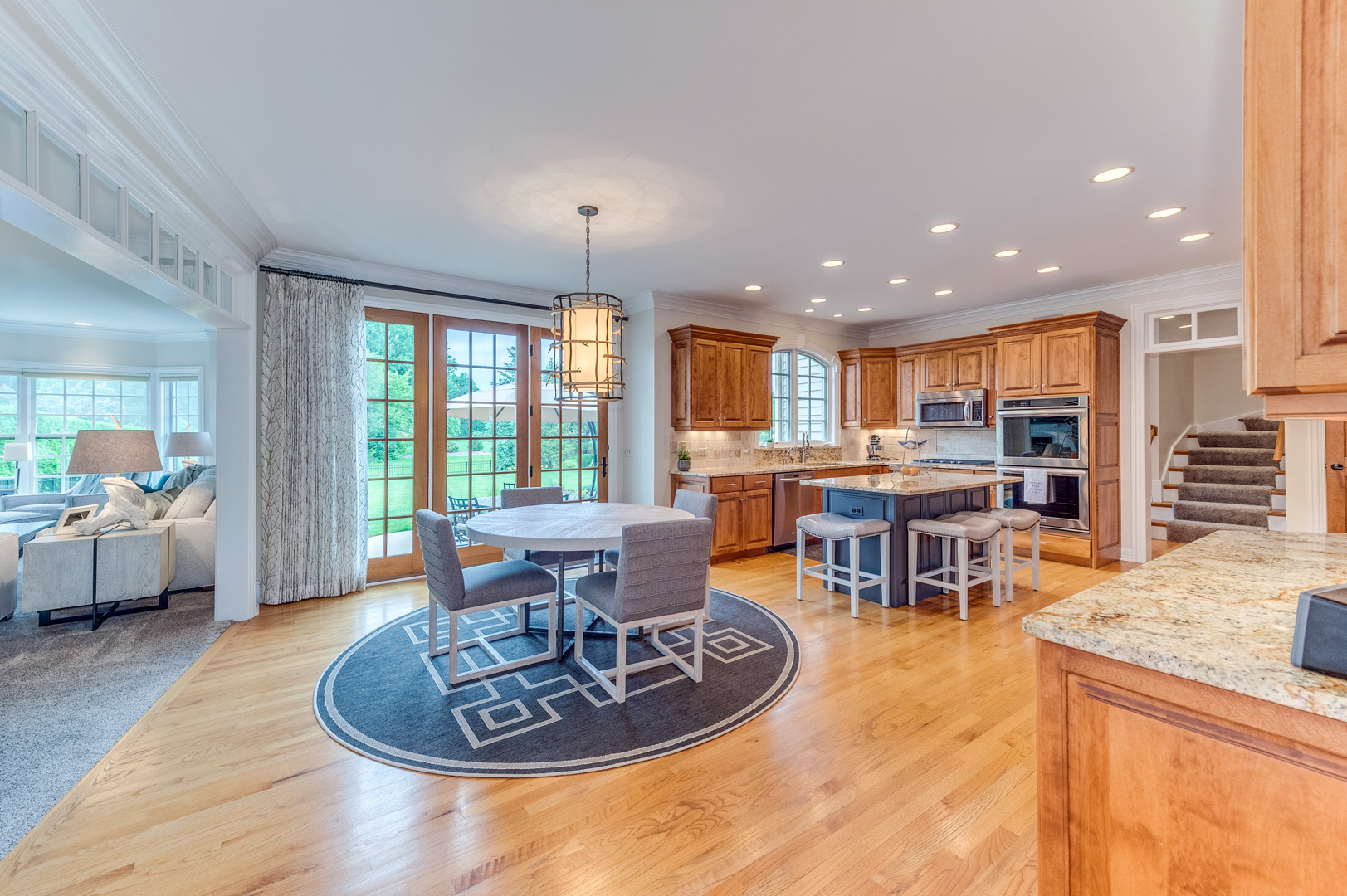 1009 Sutton Place St. Charles, IL 60174 - Photo 8 of 41 a living room with furniture a large window and kitchen view