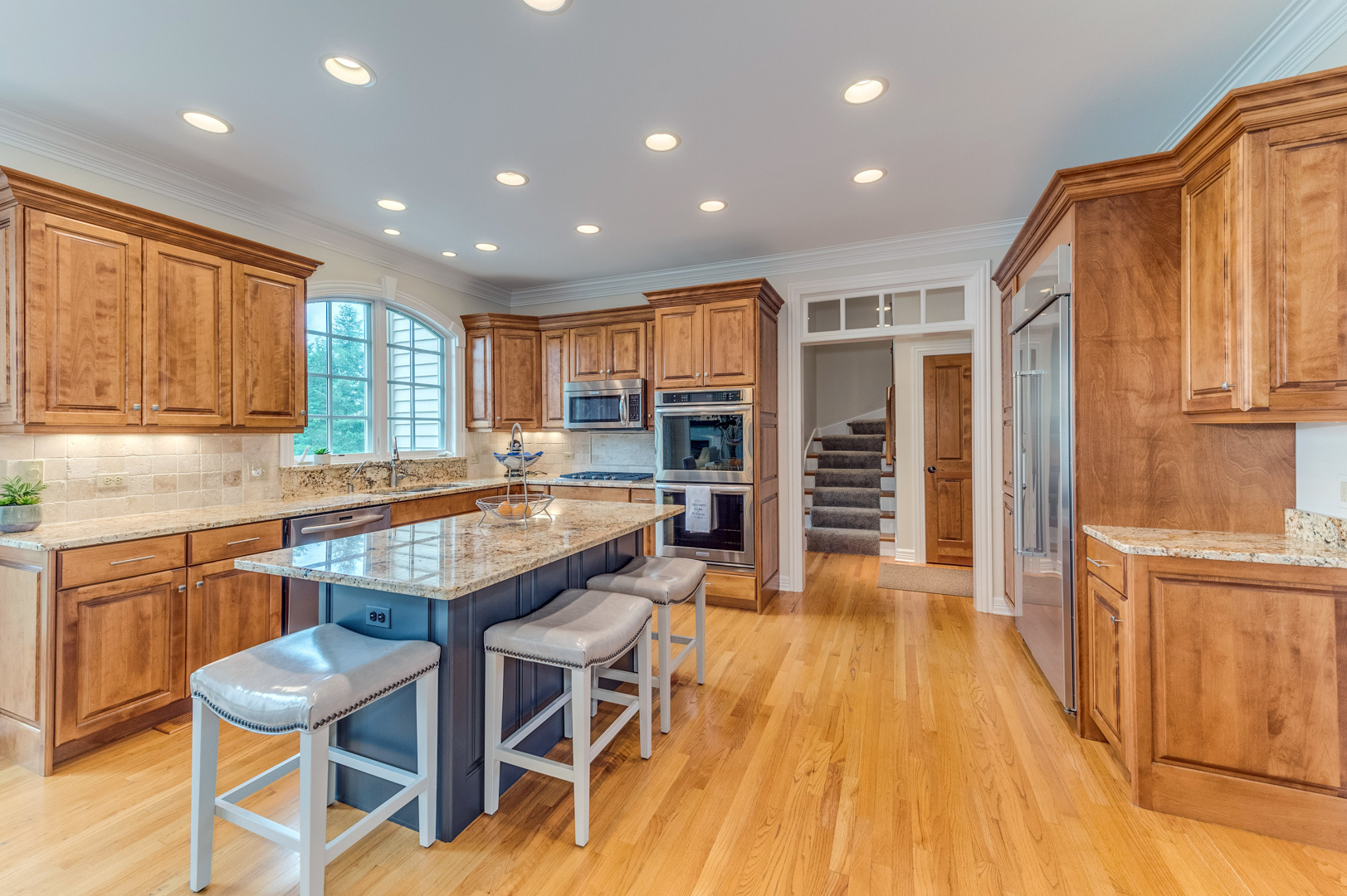 1009 Sutton Place St. Charles, IL 60174 - Photo 10 of 41 a dining hall with stainless steel appliances granite countertop a stove top oven a sink dishwasher and a refrigerator with wooden floor