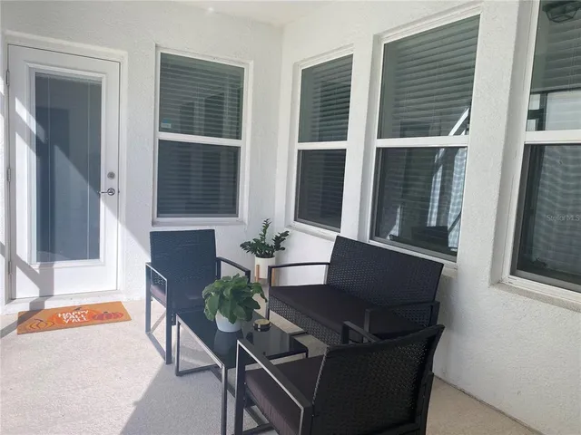 a living room with furniture and windows