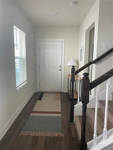 a view of entryway and hall with wooden floor