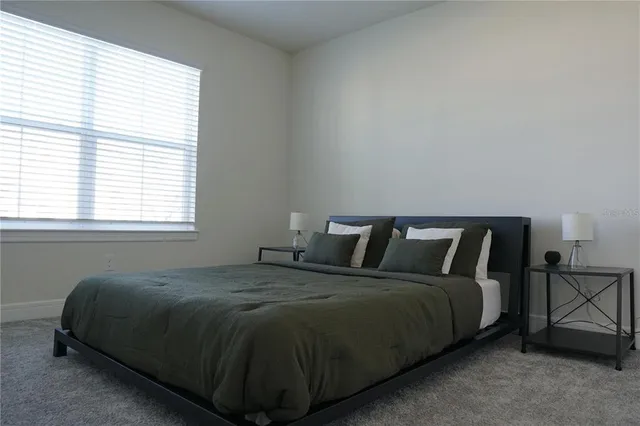 a bed sitting in a bedroom next to a window