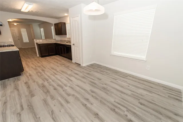 a view of kitchen with microwave oven stove refrigerator and sink