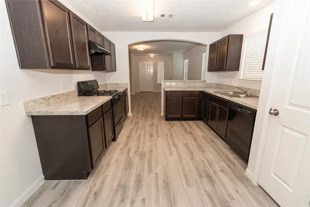 a spacious bathroom with a granite countertop sink a mirror and a shower