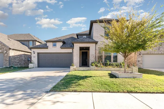 a view of a house with a yard and pathway