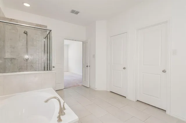 a bathroom with a bathtub and a shower