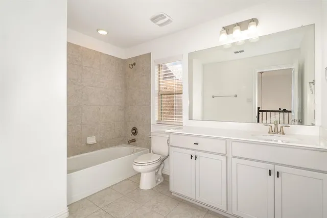 a spacious bathroom with a bathtub shower sink double vanity and mirror