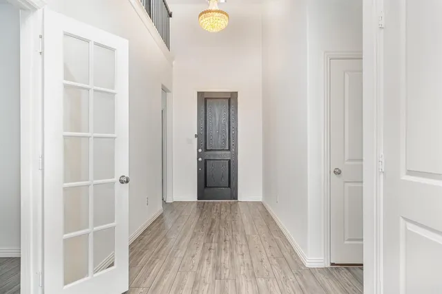 a view of a hallway with wooden floor and closet
