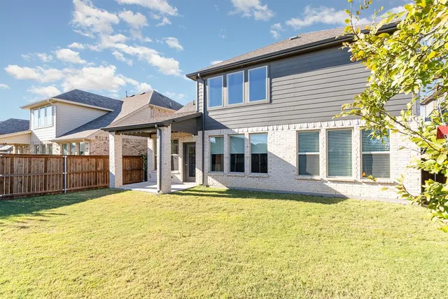 a view of a house with a yard and sitting area