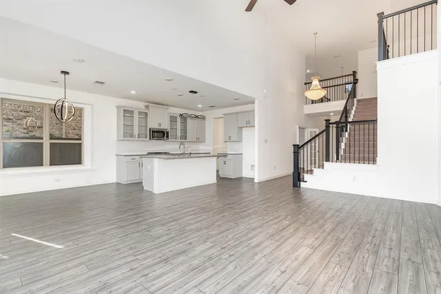 a view of a kitchen with wooden floor and a kitchen