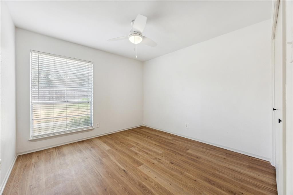 807 Castle Ridge Road, Unit A Austin, TX 78746 - Photo 13 of 15 Unfurnished room featuring light wood-type flooring and ceiling fan