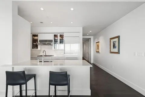 a bedroom with a large bed and a view of kitchen