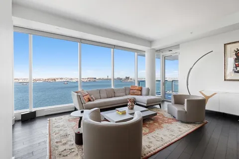 a living room with furniture and a floor to ceiling window