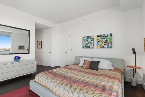 a bedroom with a large bed and a couch