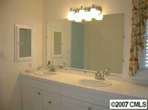 3227 Gray Moss Road Charlotte, NC 28270 - Photo 5 of 8 a bathroom with a sink and a mirror