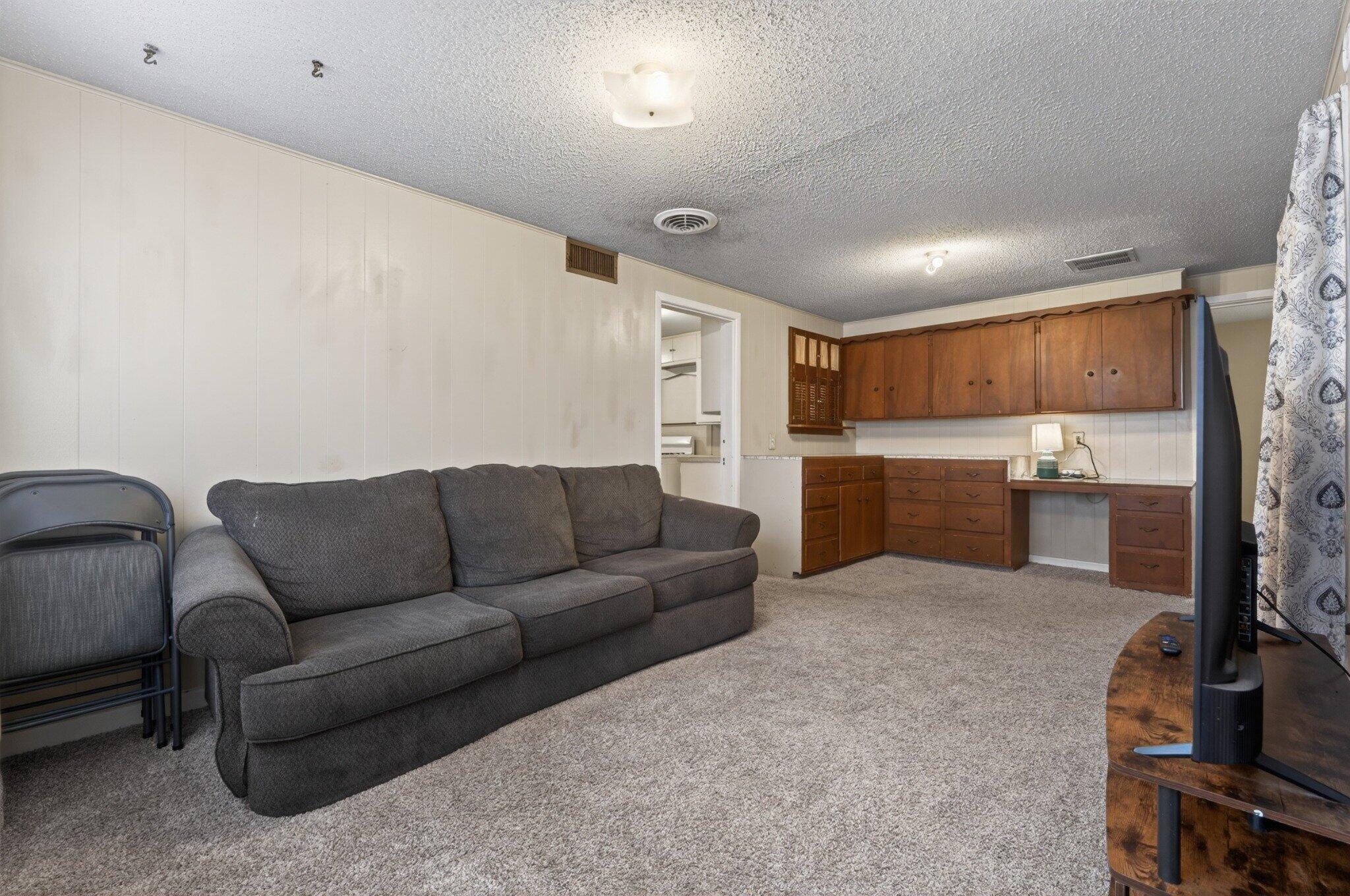 2212 22nd Street Lubbock, TX 79411 - Photo 6 of 14 a living room with furniture and a flat screen tv